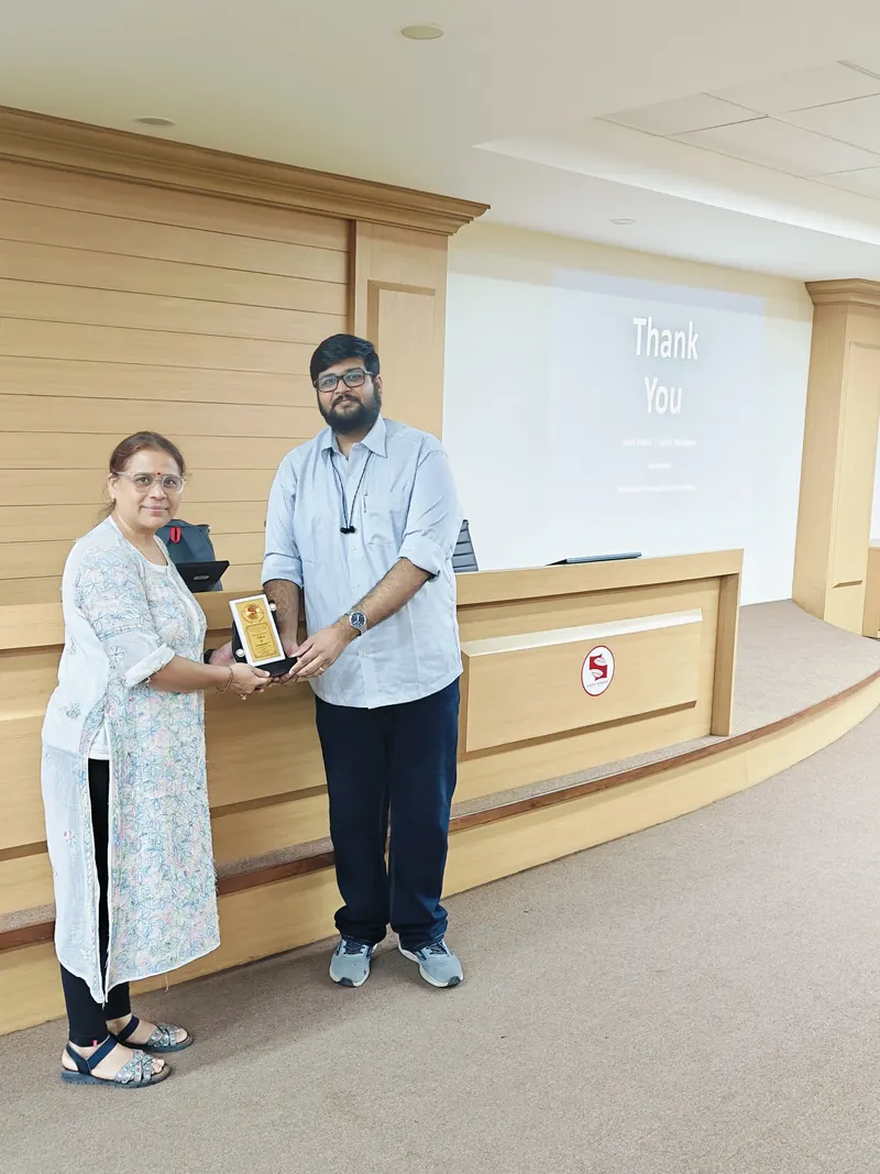 Angad Kulkarni receiving a memento after a guest session at an institute