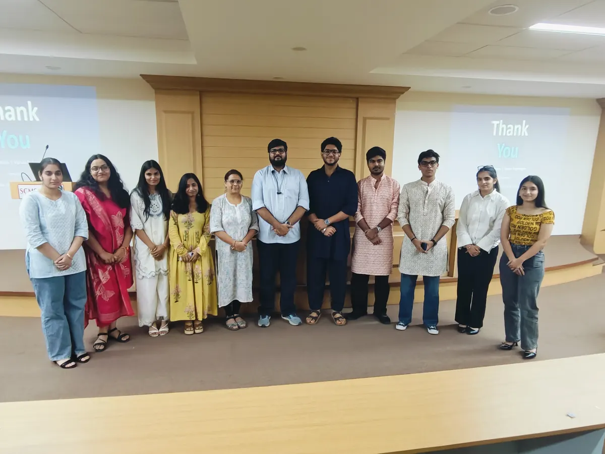 Angad Kulkarni with students after a session in an auditorium